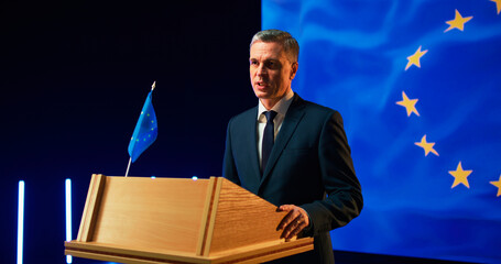 Energetic politician speaking with audience from podium