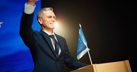 Cheerful politician greeting audience from podium