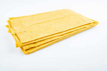 Golden dried tofu skin on white background