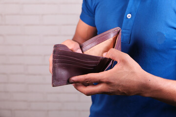 Man hand open an empty wallet with copy space.