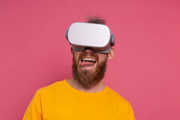 Positive fun happy man in vr glasses on studio  background