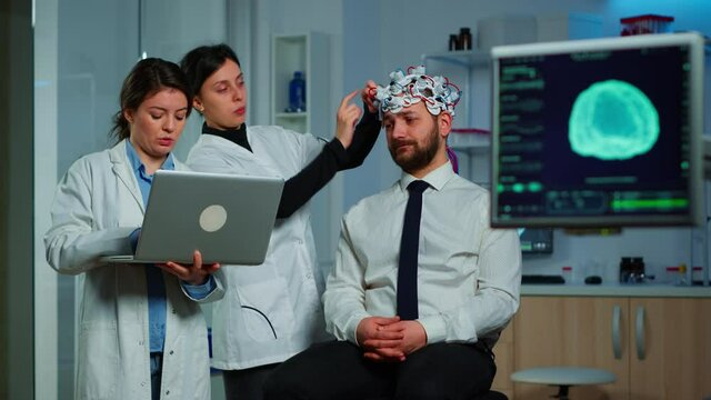 Women team neurological researchers working together developing treatment for diagnosis of braindisease, explaning eeg results, health status, brain functions, nervous system and tomography scan
