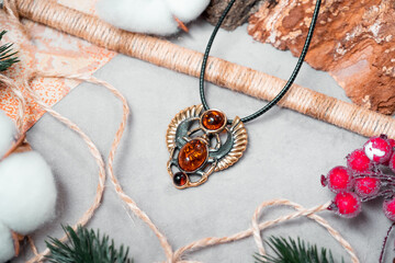 Suspension in the form of a scarab of bronze and amber