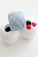 blue and white crochet yarn with red hearts