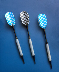 Darts on a blue ping pong table