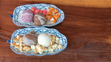 Top view various flavors of ice cream with toppings on the table