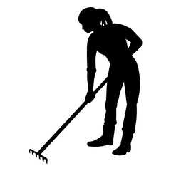 A girl gardener silhouette weeds a garden bed with a rake