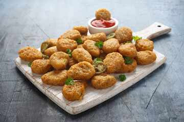 Crispy Jalapeno Popper with creamy cheese battered on white wooden board