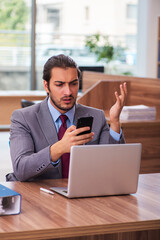 Young male employee working in the office