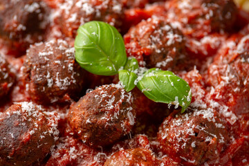 Vegetarian spaghetti with meat free, vegan meatballs in rich tomato sauce, grated cheese and basil leaves