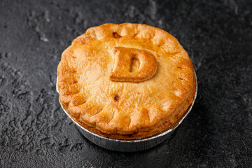 British duck pie on rustic dark background