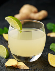 Ginger and lemon beer sparkling fizzy drink in glasses with lime wedges on the side