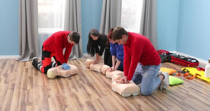 Demonstrating chest compressions on CPR doll in the class, CPR training medical procedure of model dummy. Adult CPR training and First Aid Instruction
