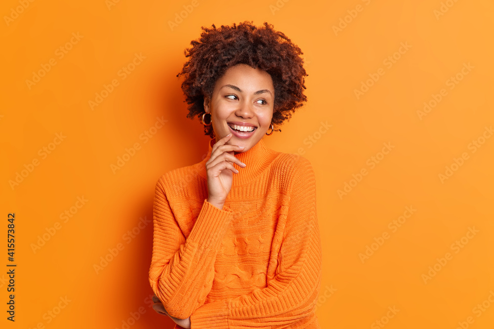 Wall mural pretty young afro american girl looks aside with toothy smile notices pleasant thing has carefree ex - Wall murals