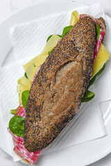 Homemade Sausage Sandwich with Lettuce and Cheese on Seed Bread