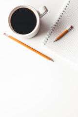 Office desk table with supplies, coffee cup and flower. Top view