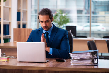 Young male employee working in the office