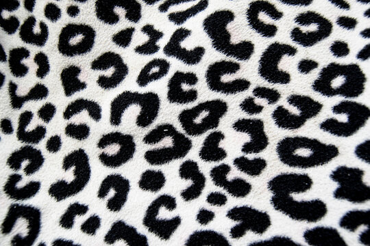 Background and detail of beige fabric texture and animal print drawings. Design elements.