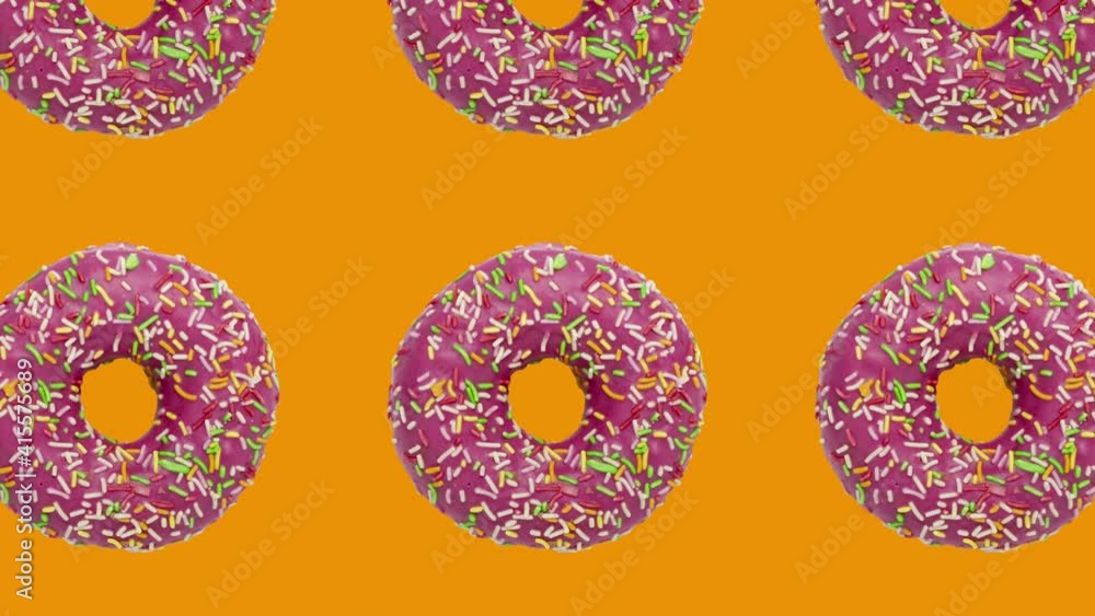 Poster pattern with pink rotating doughnuts on an orange background. simple motion graphics food animation
