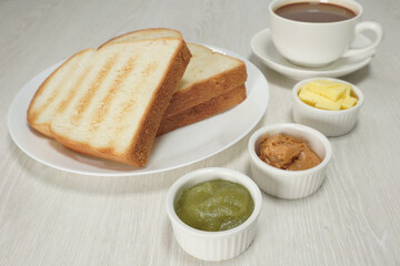 Morning breakfast toasted bread butter kaya peanut with coffee