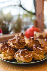 Homemade profiteroles with cream, raspberries and blackberries.