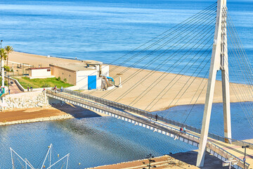 View from the Sohail castle overlooking a river, bridge, beach and sea in Fuengirola, Spain.