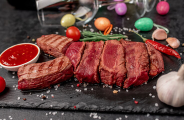 Easter bunny from beef with different roasting of meat
, wine bottle and glasses on a stone background with copy space for your text. Easter celebration concept