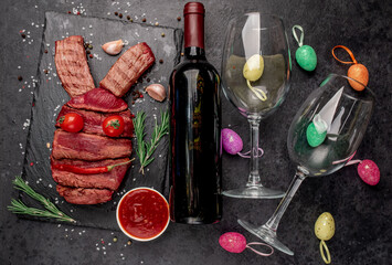 Easter bunny from beef with different roasting of meat
, wine bottle and glasses on a stone background with copy space for your text. Easter celebration concept
