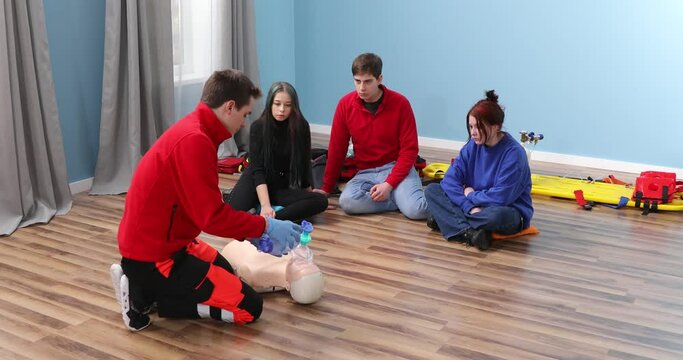 Adult CPR training and First Aid Instruction. Students in class exercising reanimation on dummy. CPR Training.