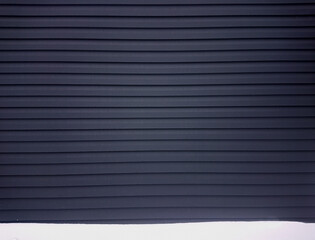 Obraz premium Snow and dark blue wall. Winter urban background.