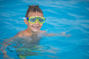 Cute little boy in a swimming pool