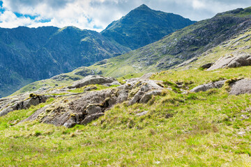 Fototapeta na wymiar Trekking in British mountains, United Kingdom, view of the mountains, lake, stone wall, selective focus