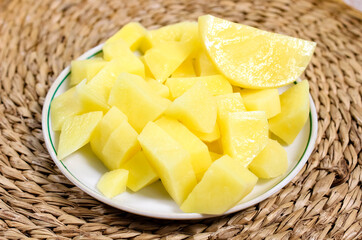 Sliced raw potatoes on a plate. Vegetables for cooking.