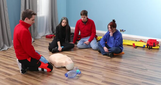 Adult CPR training and First Aid Instruction. Students in class exercising reanimation on dummy. CPR Training.