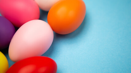 Flat lay set of decorated hand painted chaotically scattered colorful eggs on blue background. Happy Easter concept composition. Image with copy free space for text message
