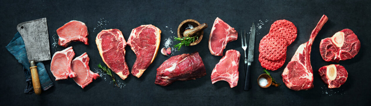 Variety of raw cuts of meat, dry aged beef steaks and hamburger patties