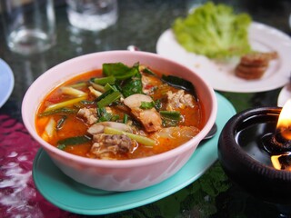 Spicy Pork Soup Tom Yum with herb in a bowl