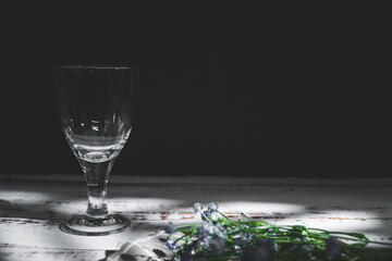 on the table there is a wine glass and cup Coffee, in accordance with the romantic mood and there...