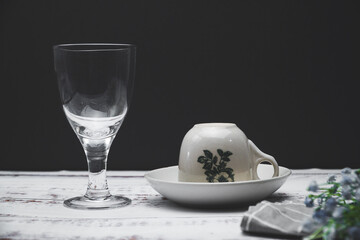 on the table there is a wine glass and cup Coffee, in accordance with the romantic mood and there is space for writing
