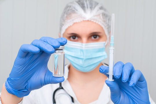 nurse holding ampoule with vaccine and syringe. Vaccination concept.