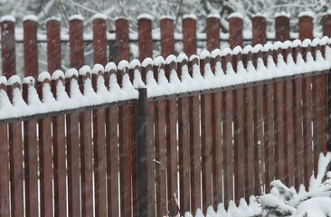 Wood fence under fresh snow