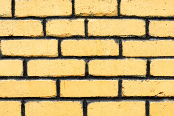 Fototapeta premium Texture of a brick wall with cracks and scratches which can be used as a background