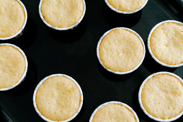 freshly baked cupcakes on a black protvin background.Food for breakfast. Freshly baked cupcakes for dessert. Foodies and cuisine.