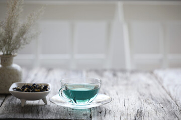 Blue pea flower juice on wooden table
