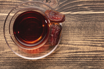 A cup of tea and dried dates. Top view