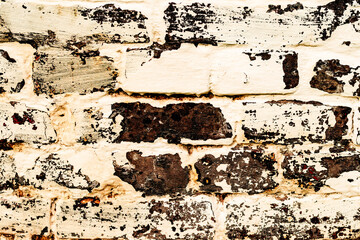 Texture of a brick wall with cracks and scratches which can be used as a background