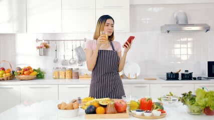 Portrait of smiling chef woman standing on kitchen. Smiling housewife looking at camera on modern kitchen in slow motion. Portrait of young woman posing in cooker apron at home