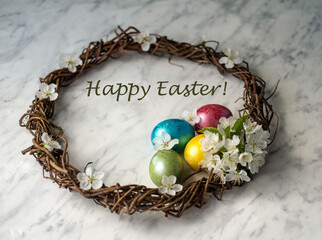 Fototapeta na wymiar Happy Easter greeting card with Easter wreath, dyed eggs and spring flowers