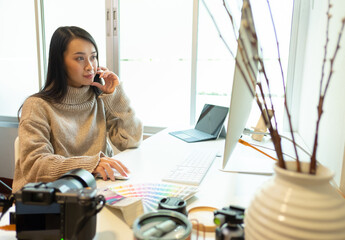 Cropped shot of two UI developers meeting on their project with paperwork and tablet on meeting...