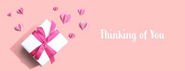 Thinking of you message with a gift box and paper hearts